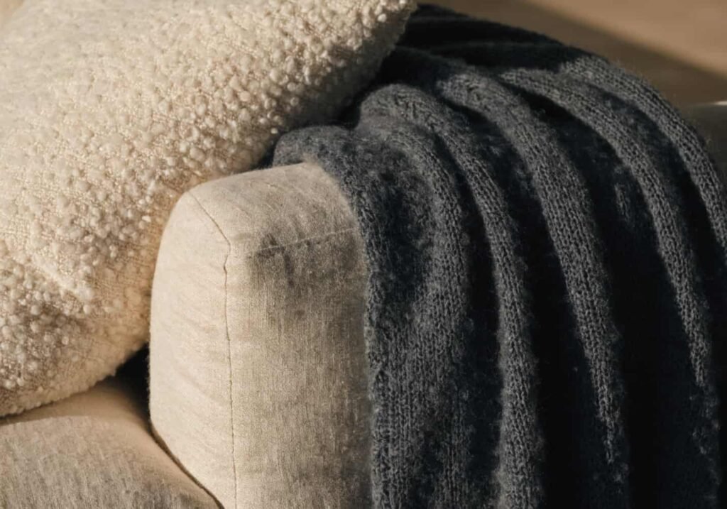 Layered fabric textures on a sofa for a cozy textural look
