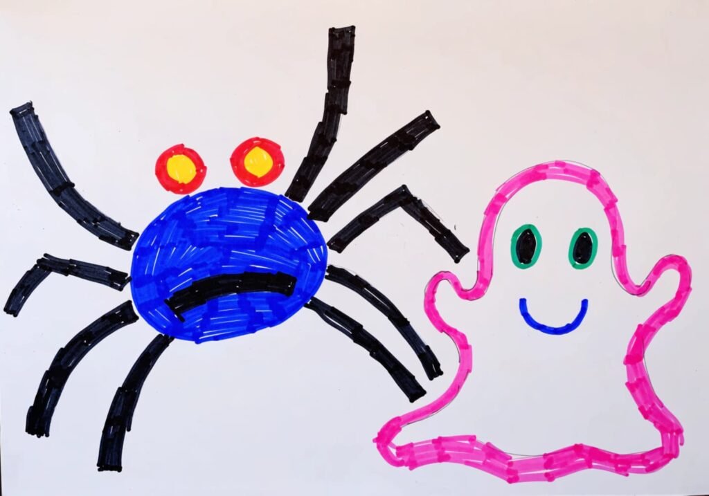 Simple kid-friendly spider and ghost drawings made with thick markers on a white board.