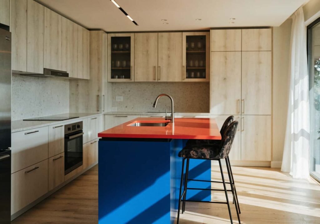 Two-tone kitchen cabinets with a bold colorful island