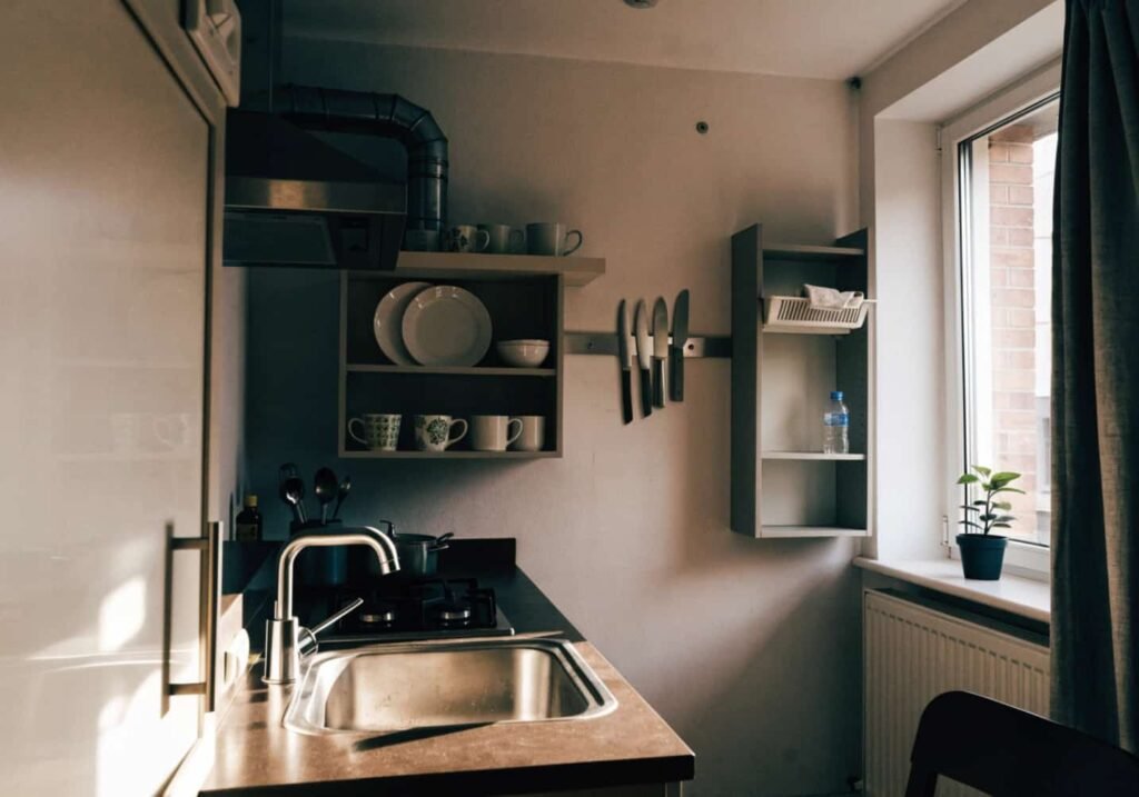 Cozy farmhouse style open shelving in a rustic kitchen.