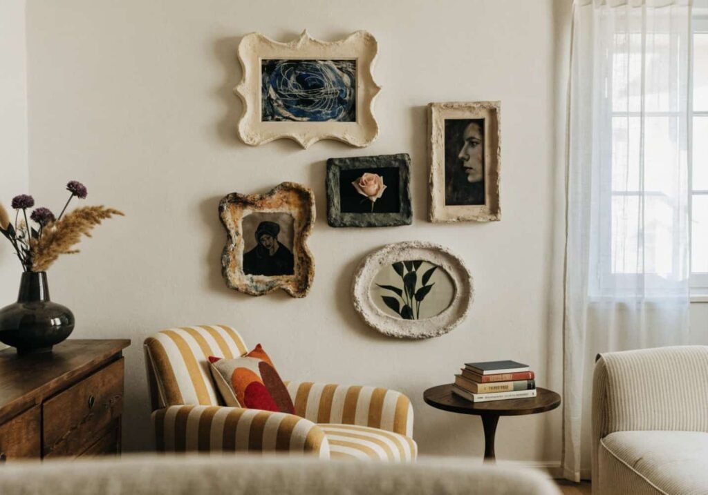 Handmade plaster-textured frames arranged as a living room gallery wall