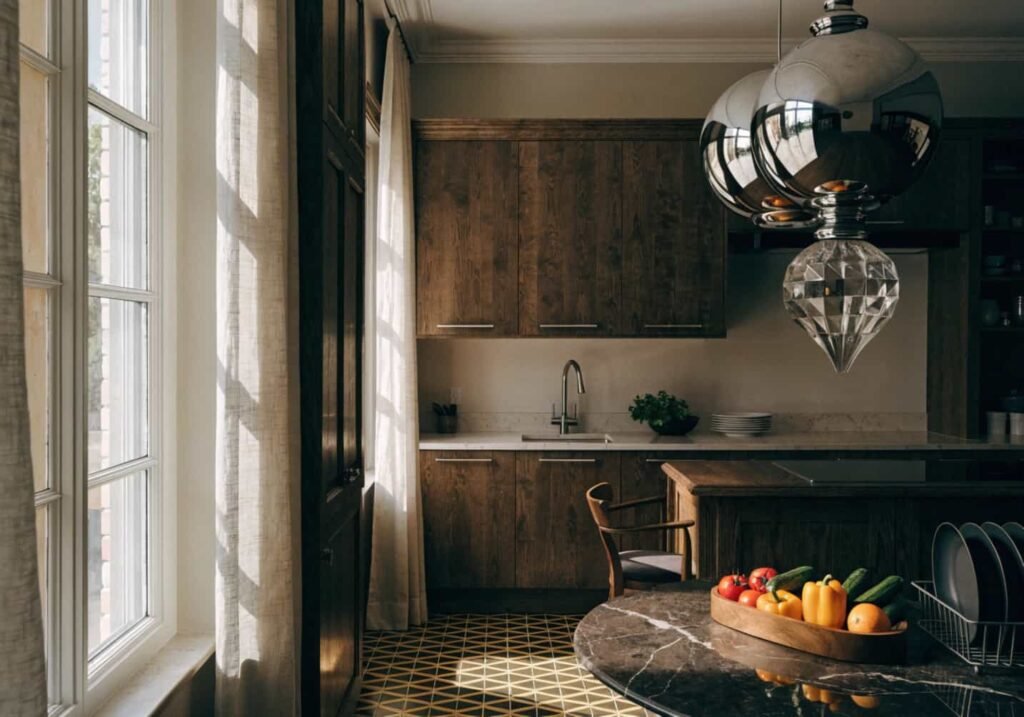 Chrome pendant light and geometric floor tiles in 1920s-inspired Neo Art Deco kitchen