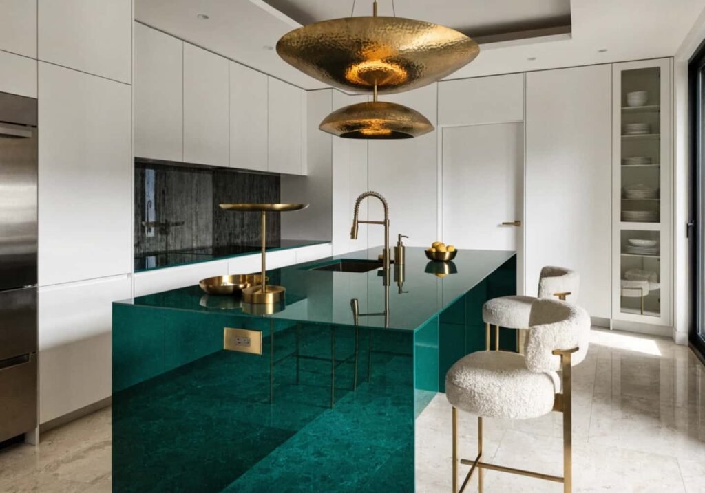 Bold emerald green kitchen island with brass fixtures