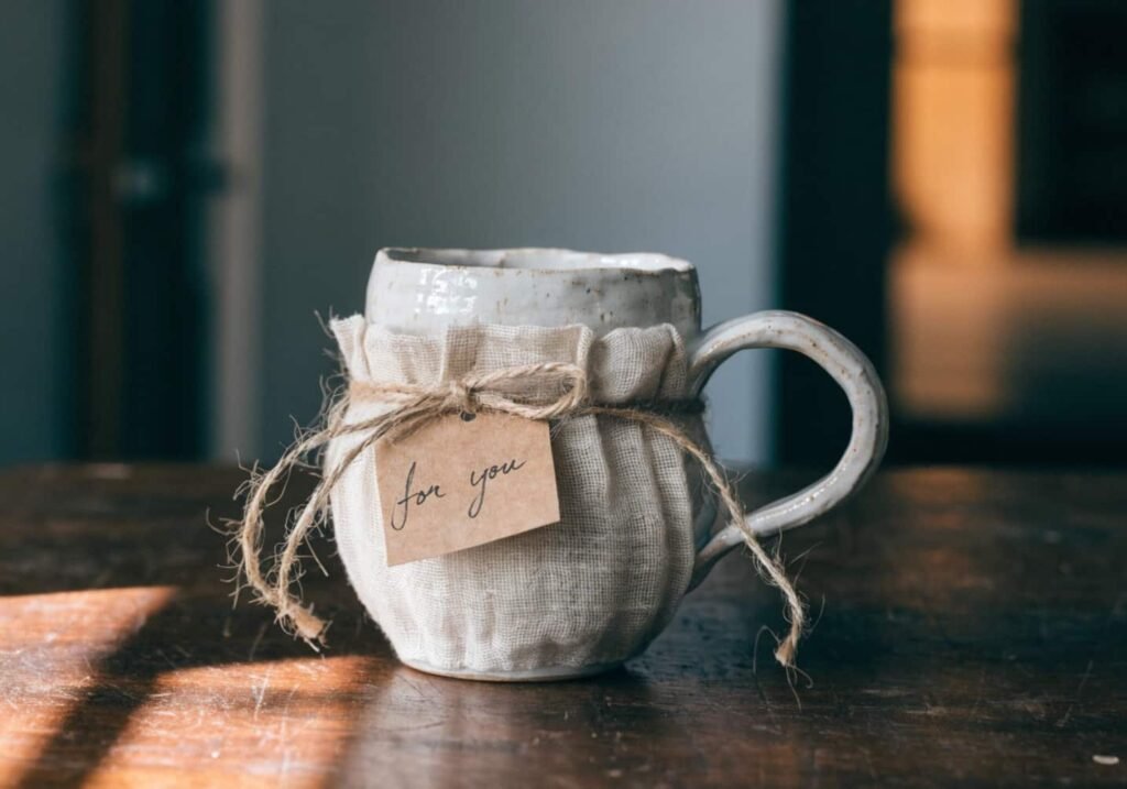 Handmade ceramic mug gift-wrapped in muslin and twine