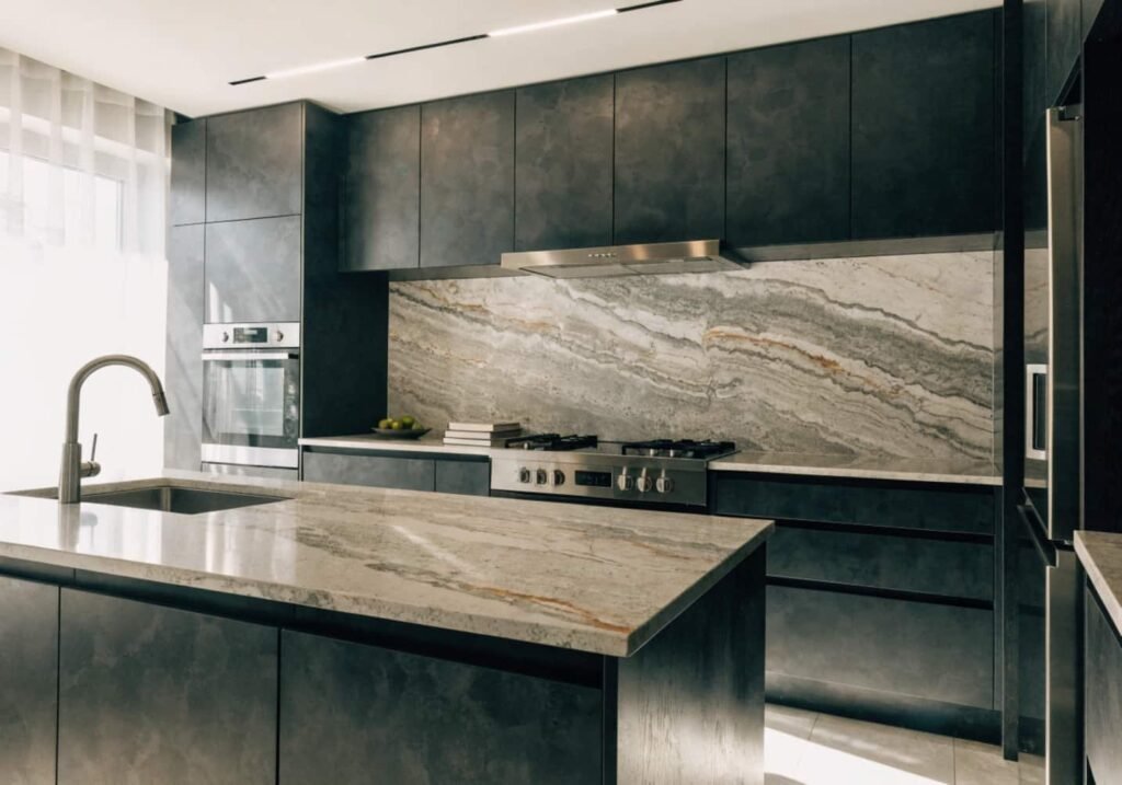 Charcoal black matte kitchen cabinets with modern lighting