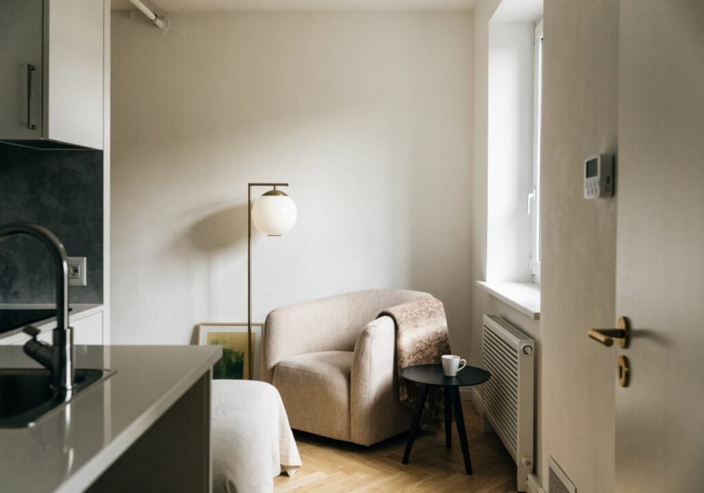 Small space with one concentrated cozy corner featuring a chair and lamp