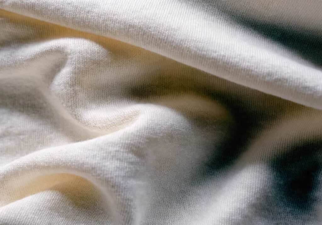 Close-up of combed ring-spun cotton jersey fabric texture"]