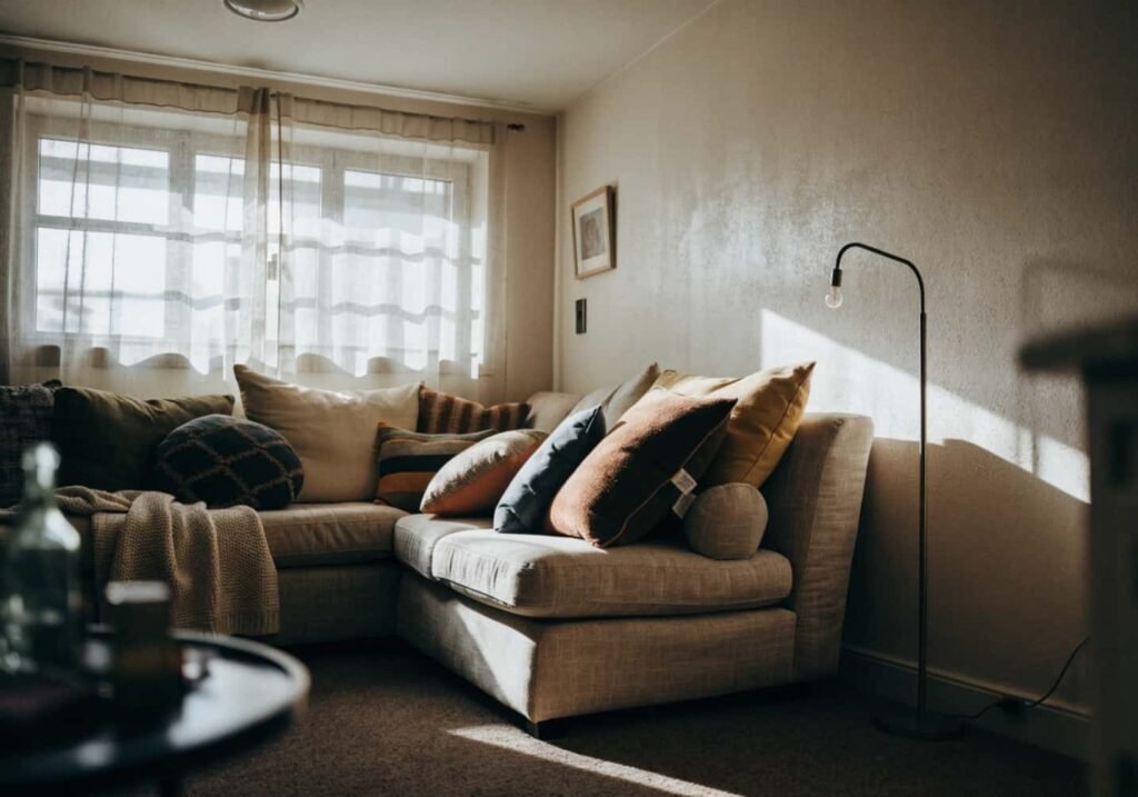 Compact L-shaped couch placed in the corner of a small apartment