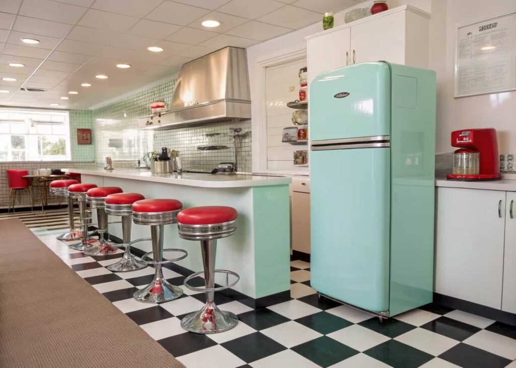 Vintage 1950s retro kitchen with pastel mint fridge and checkerboard flooring