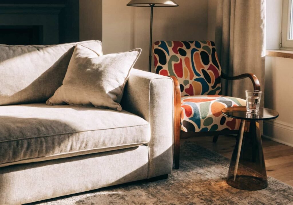 Neutral couch paired with a bold patterned accent chair for extra seating