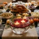 Glass bowl cranberry floating candle centerpiece glowing on a Thanksgiving table