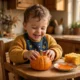 Toddler exploring a small pumpkin on a tray