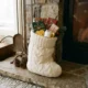 Filled Christmas stocking with small gifts by a fireplace