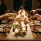 Candlelit hygge Thanksgiving table with a chunky knit runner and jars of glowing candles