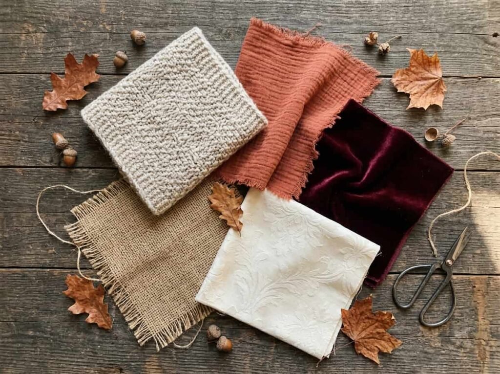 Flat lay of fall table runner fabric swatches in knit, gauze, velvet, burlap and damask