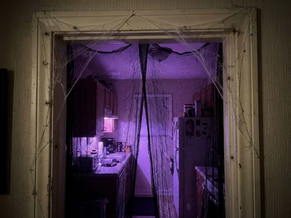 Kitchen entrance with black gauze curtain and cobwebs for Halloween