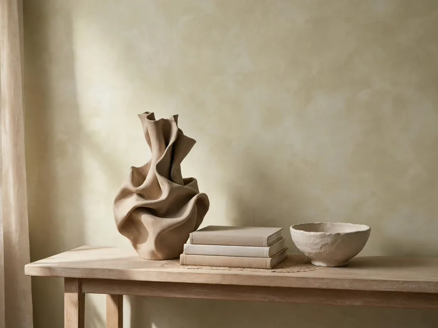 Console table styled with grouped ceramics and space